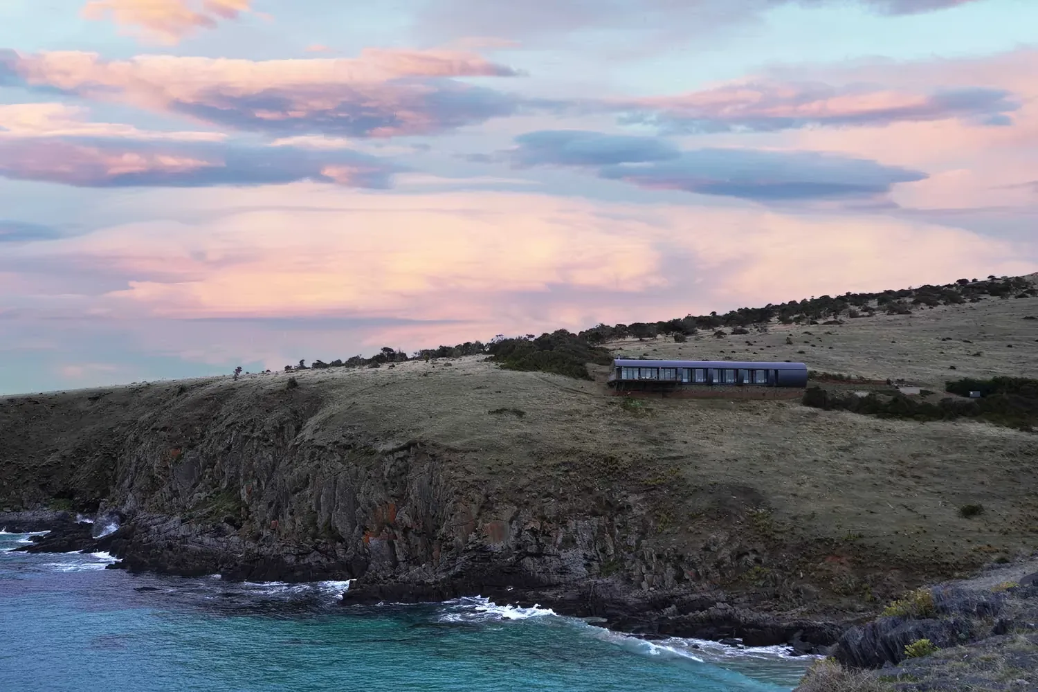 Naiko Retreat on the clifftop, photographed from above the Southern Ocean