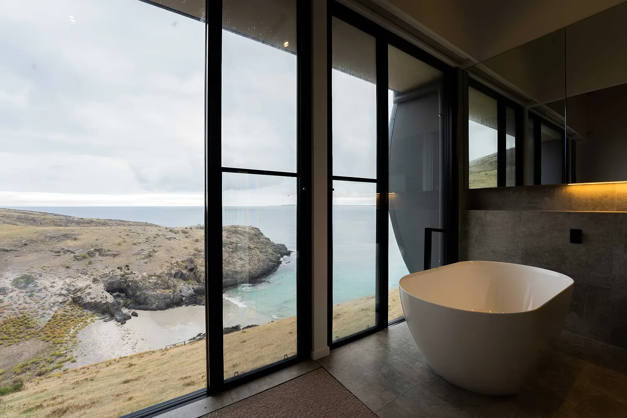 Freestanding bath positioned to look over the cove