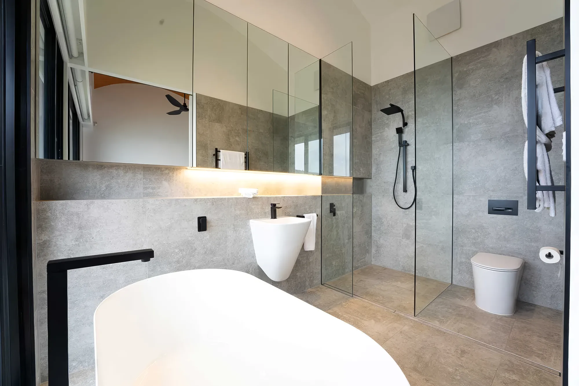 Stone-toned ensuite with walk-in shower