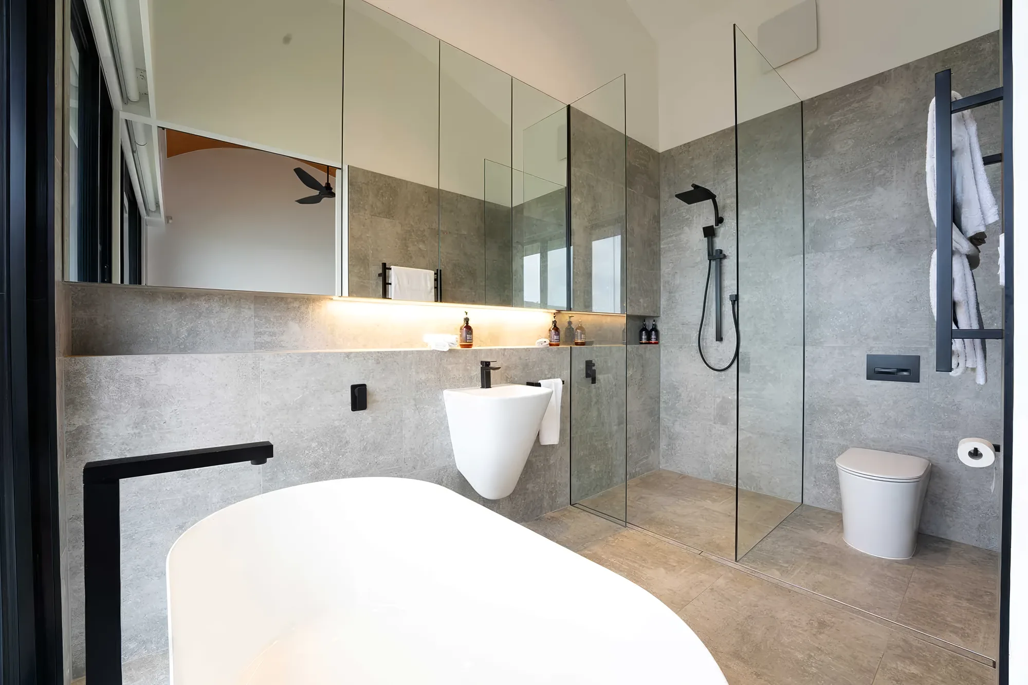 Ensuite bathroom with rain-head shower and freestanding bath