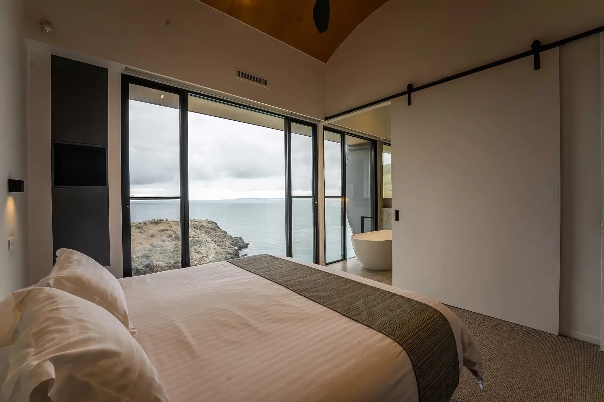King bedroom with sliding glass onto the view