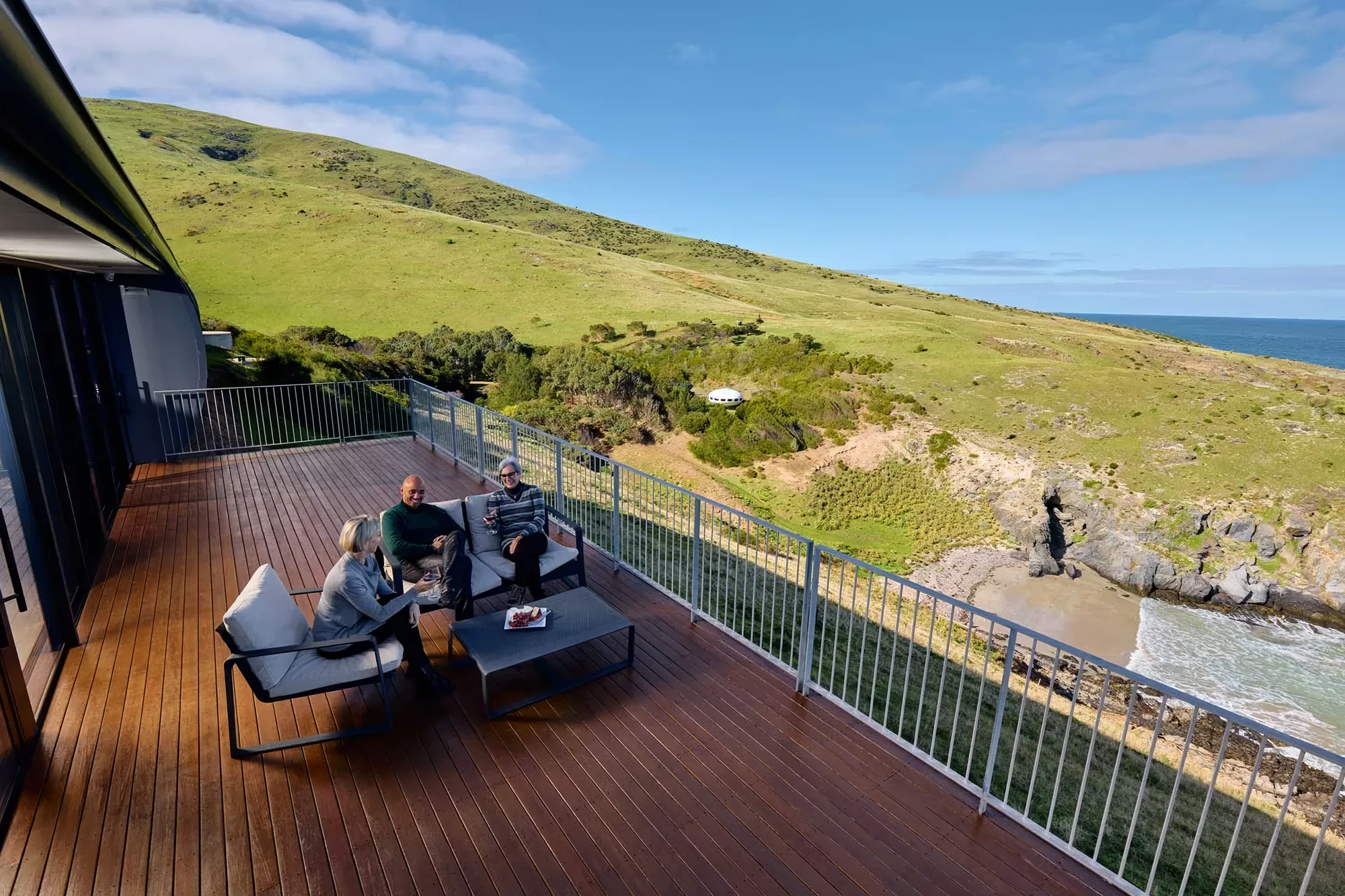 Guests on the deck looking out over the cove