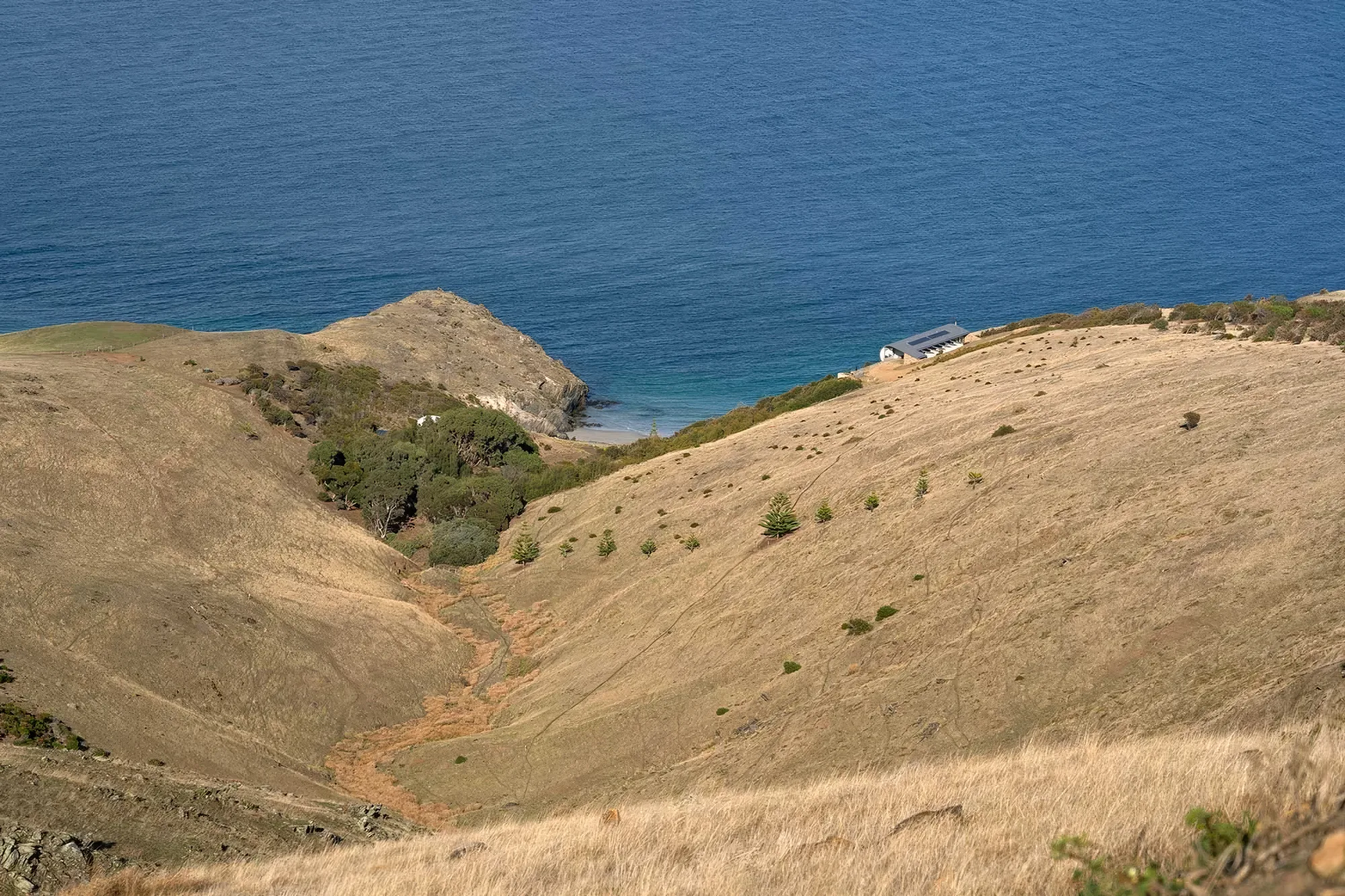 Hills falling away to a sheltered cove