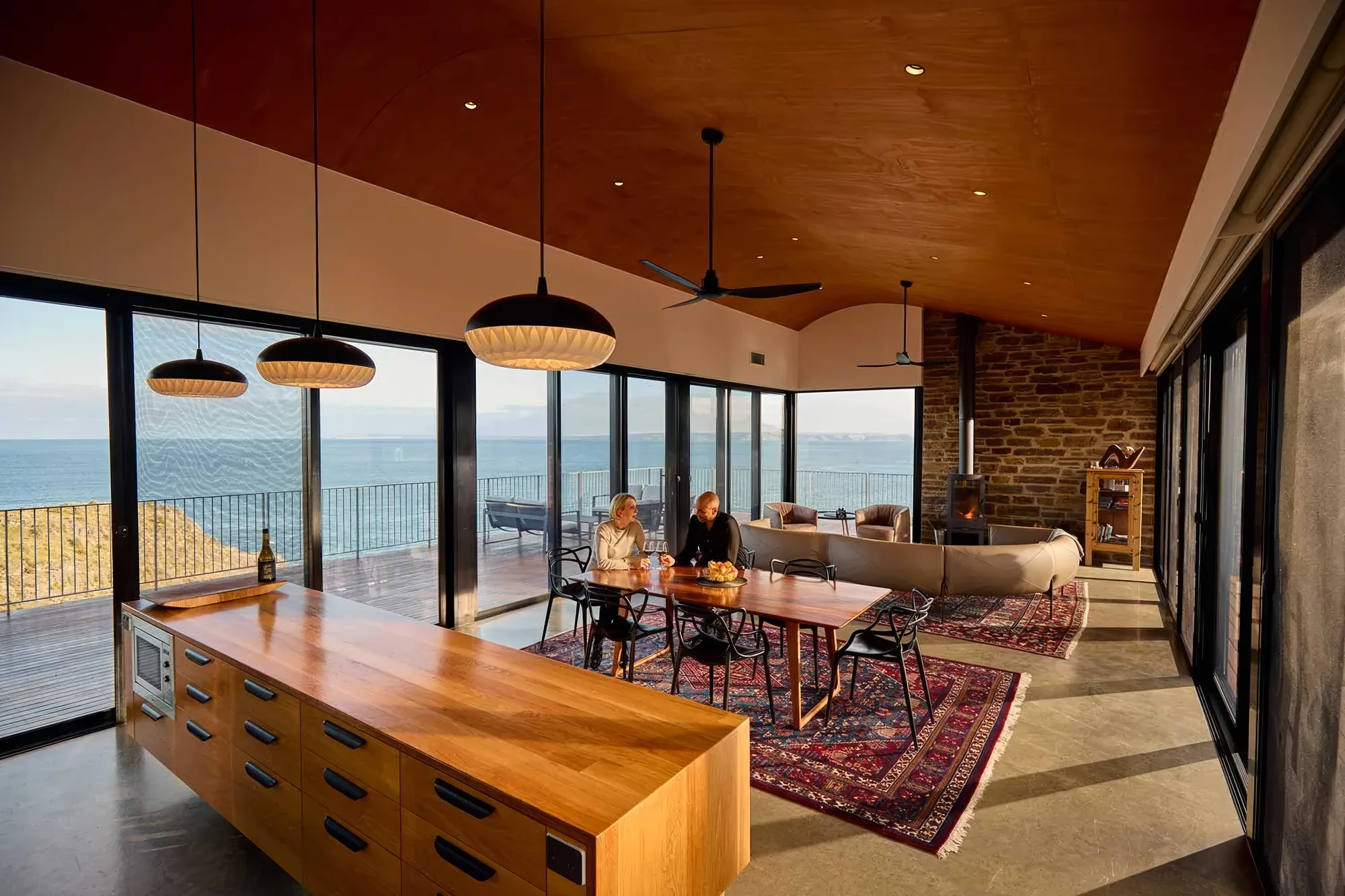 The kitchen and dining table looking out to the ocean