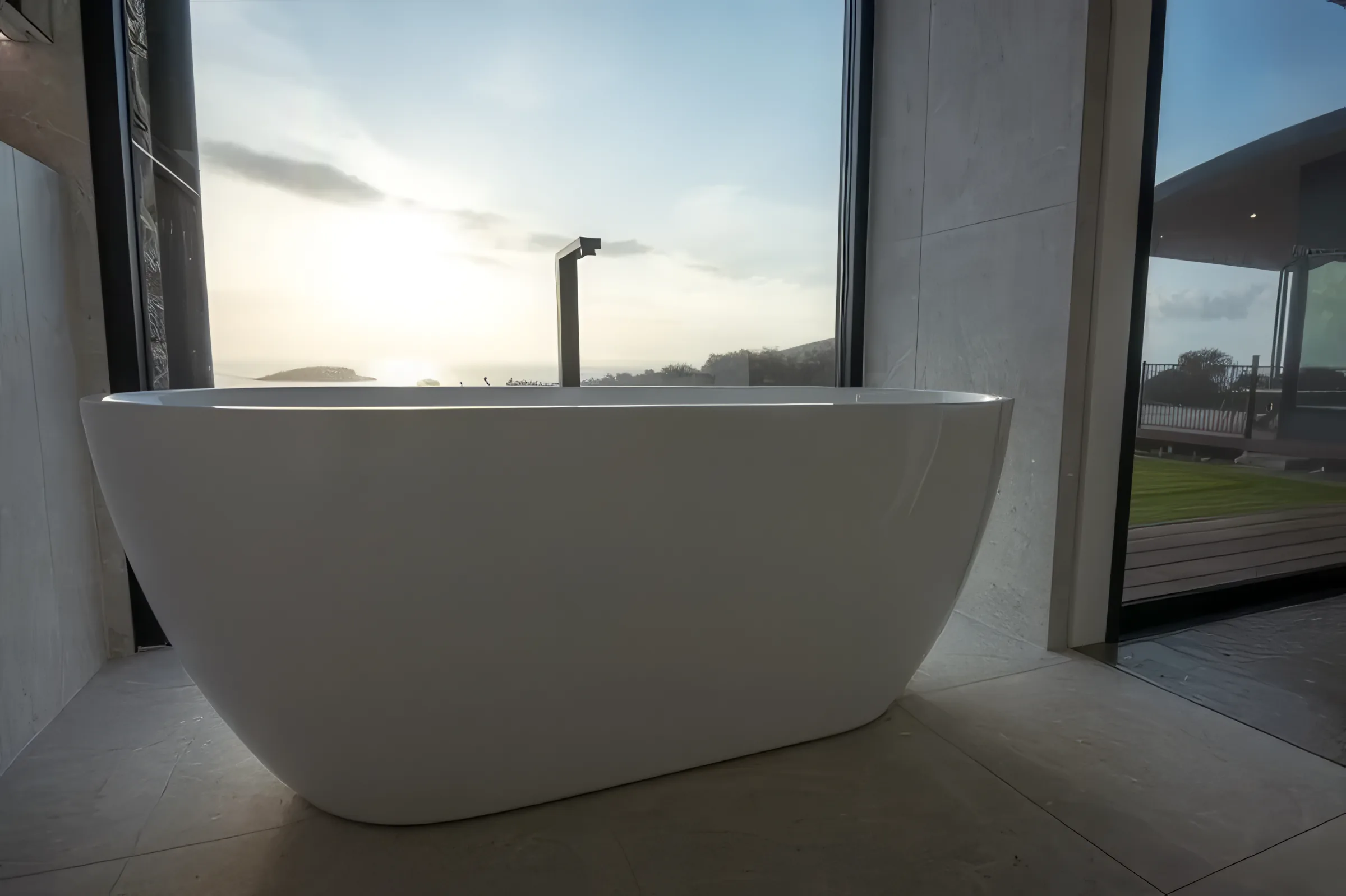 Bath positioned beside full-height glass