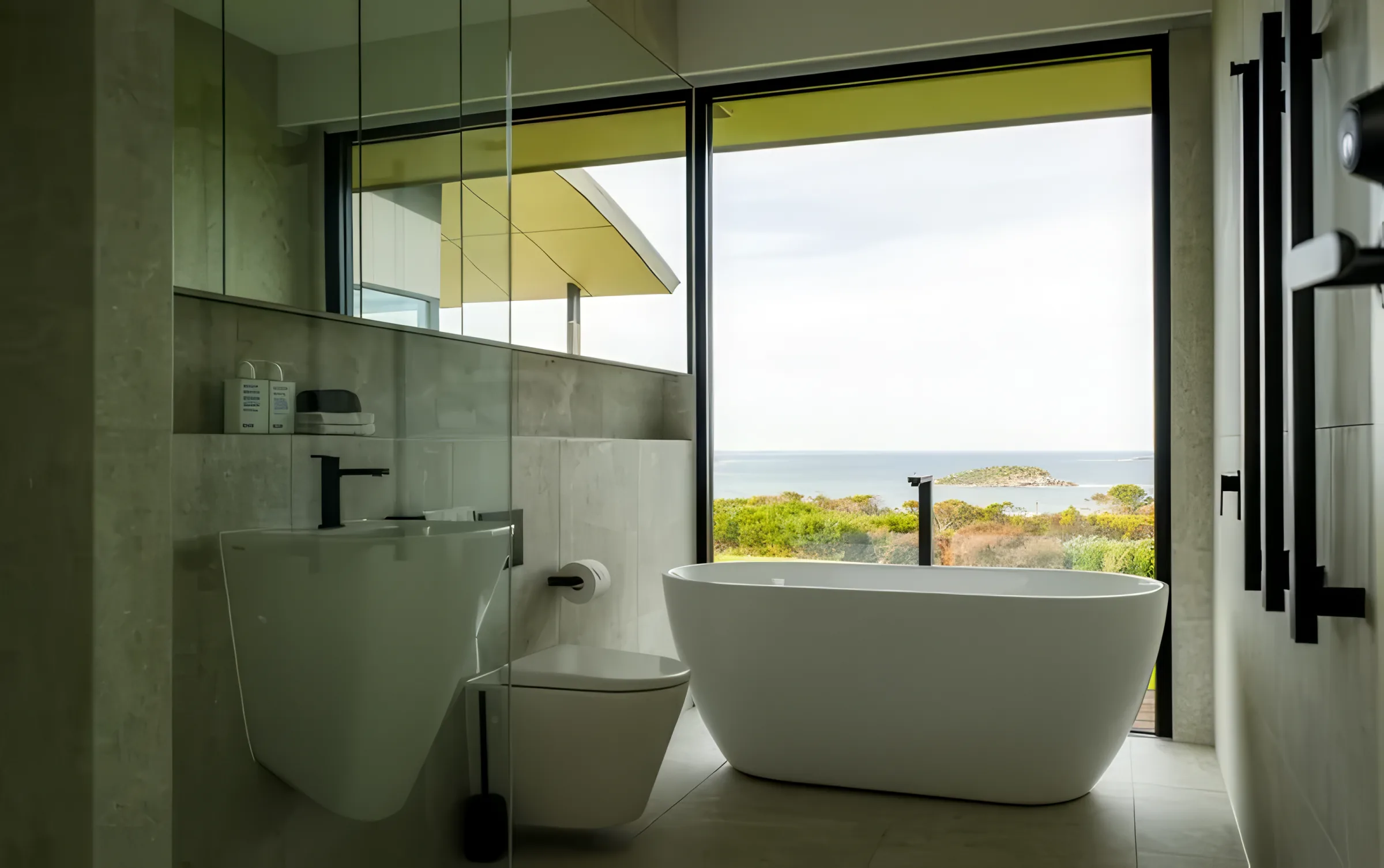 Ensuite bath and basin with a sea view